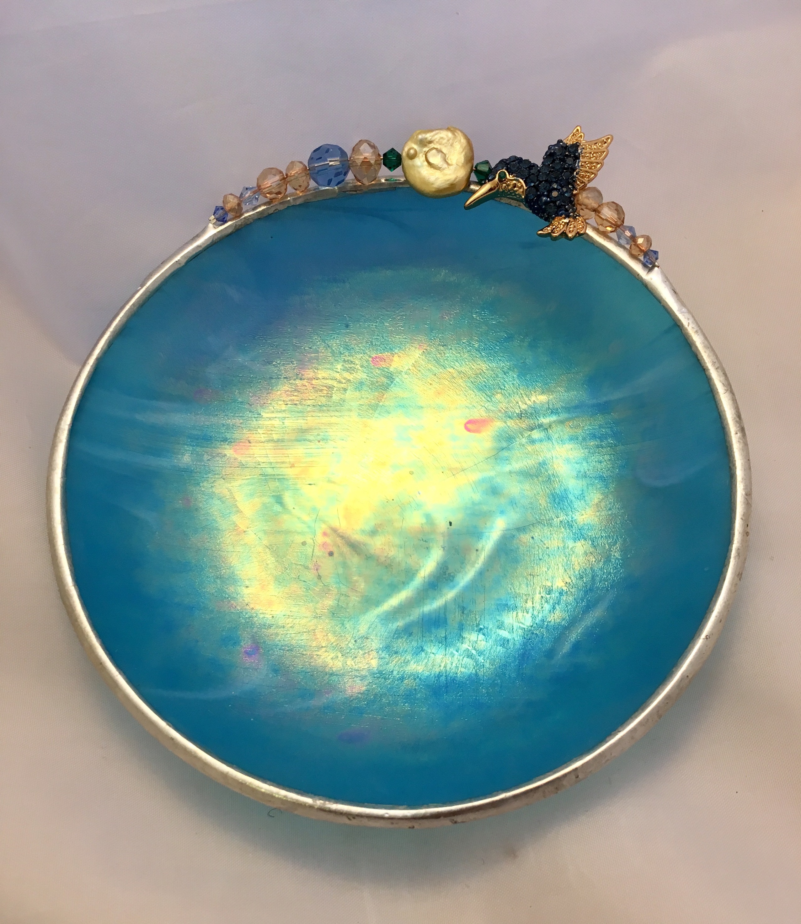 A blue bowl with some kind of picture on it