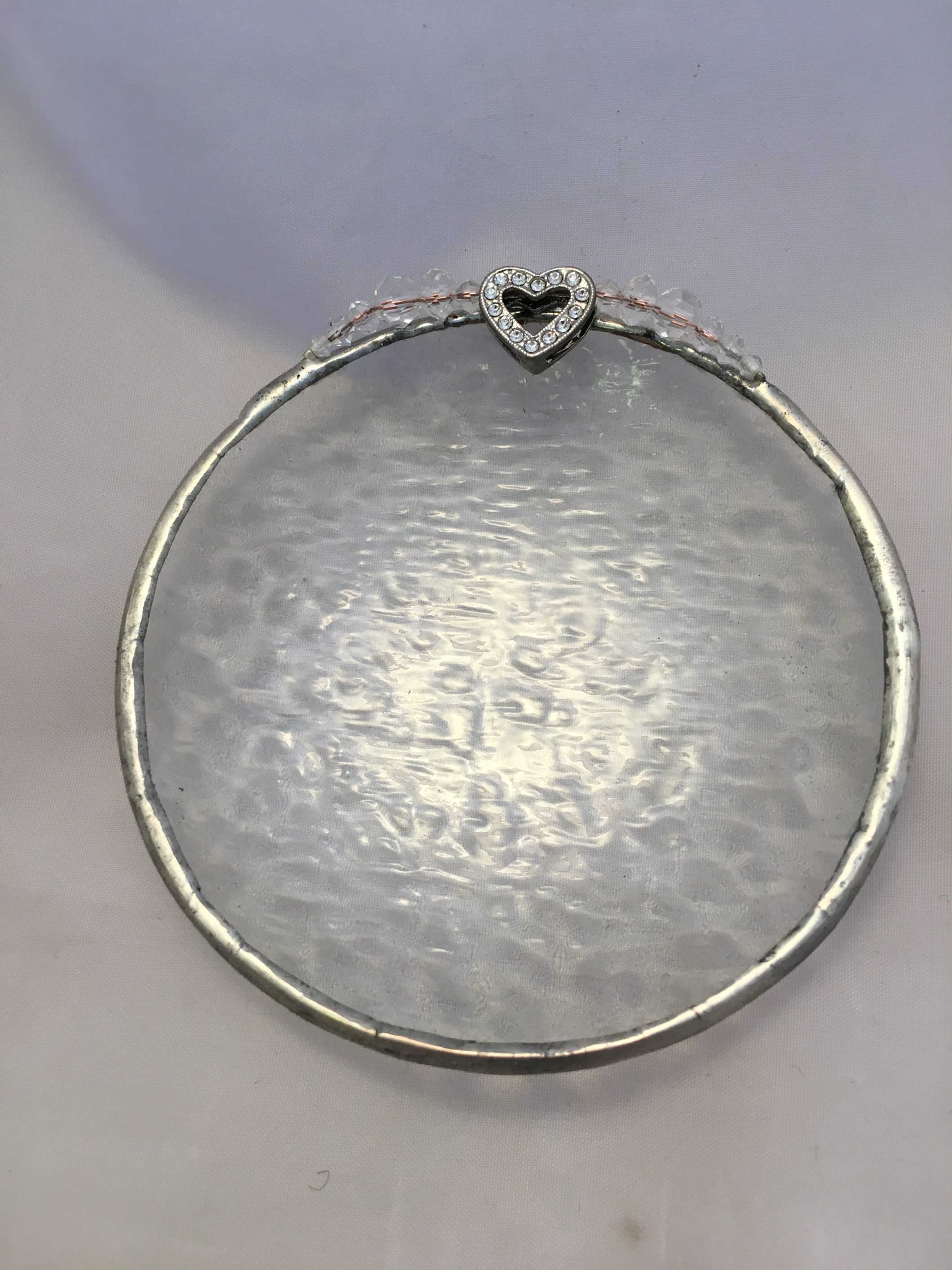 A silver plate with a heart on top of it.