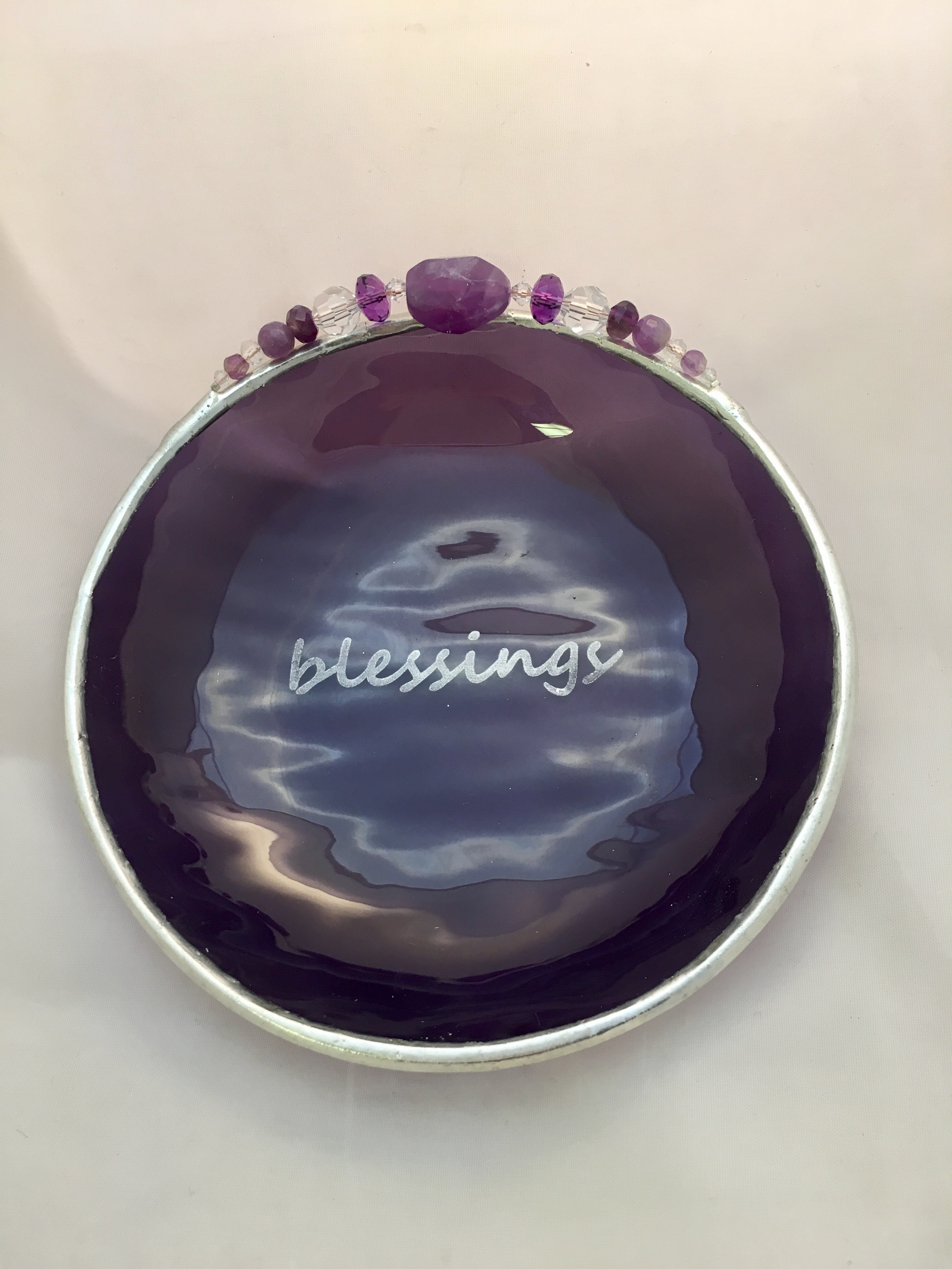 A purple dish with the word blessings written on it.