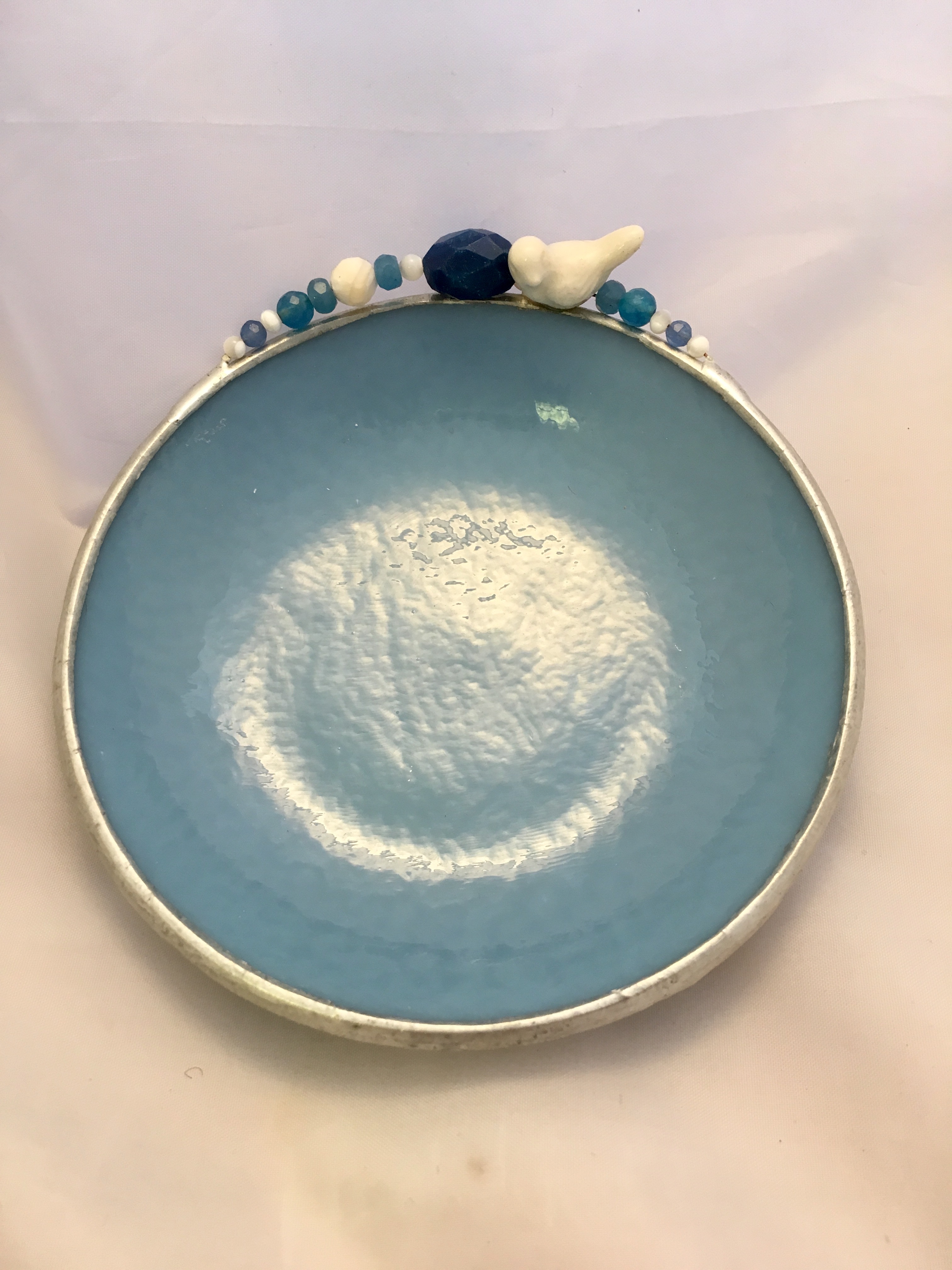 A blue plate with shells on top of it.