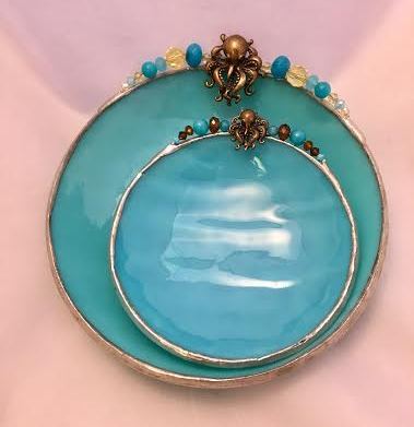 A blue plate and bowl with gold trim.