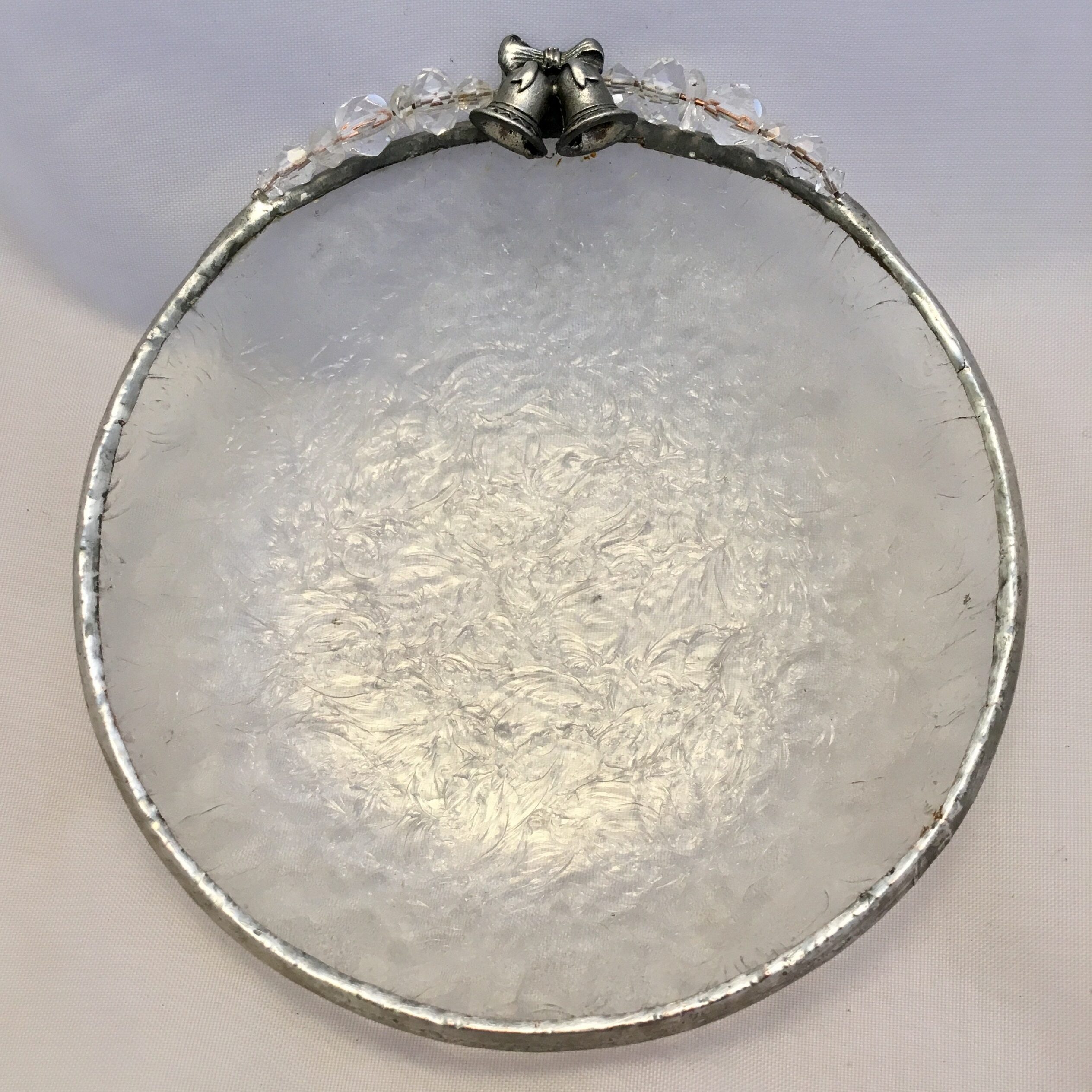 A silver plate with a metal ring on top of it.