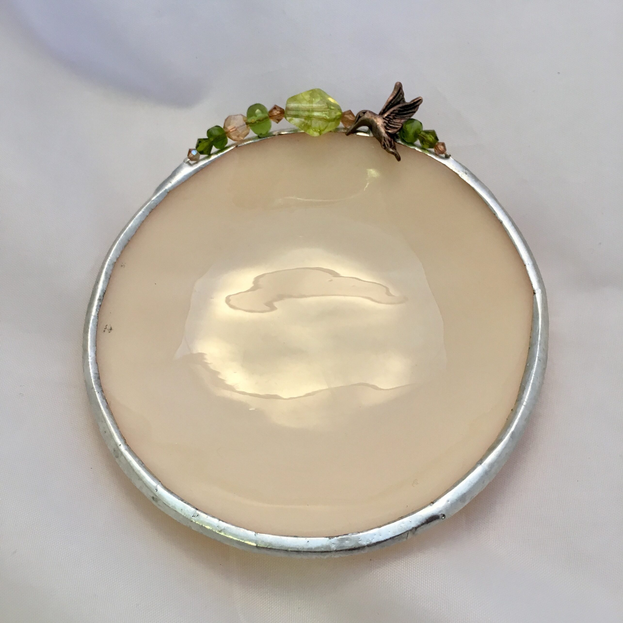 A white plate with some green leaves on it