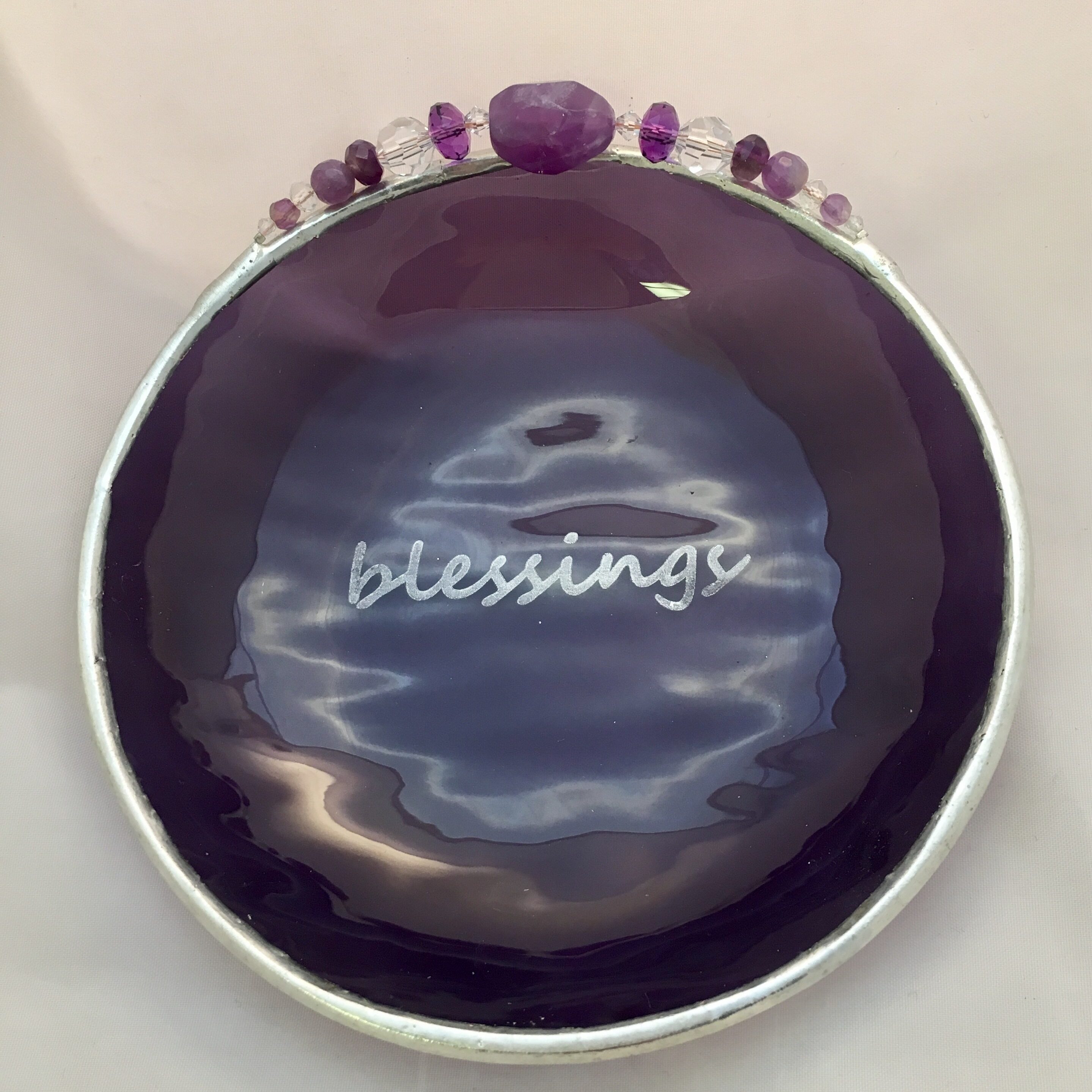 A purple bowl with the word " blessings " written on it.