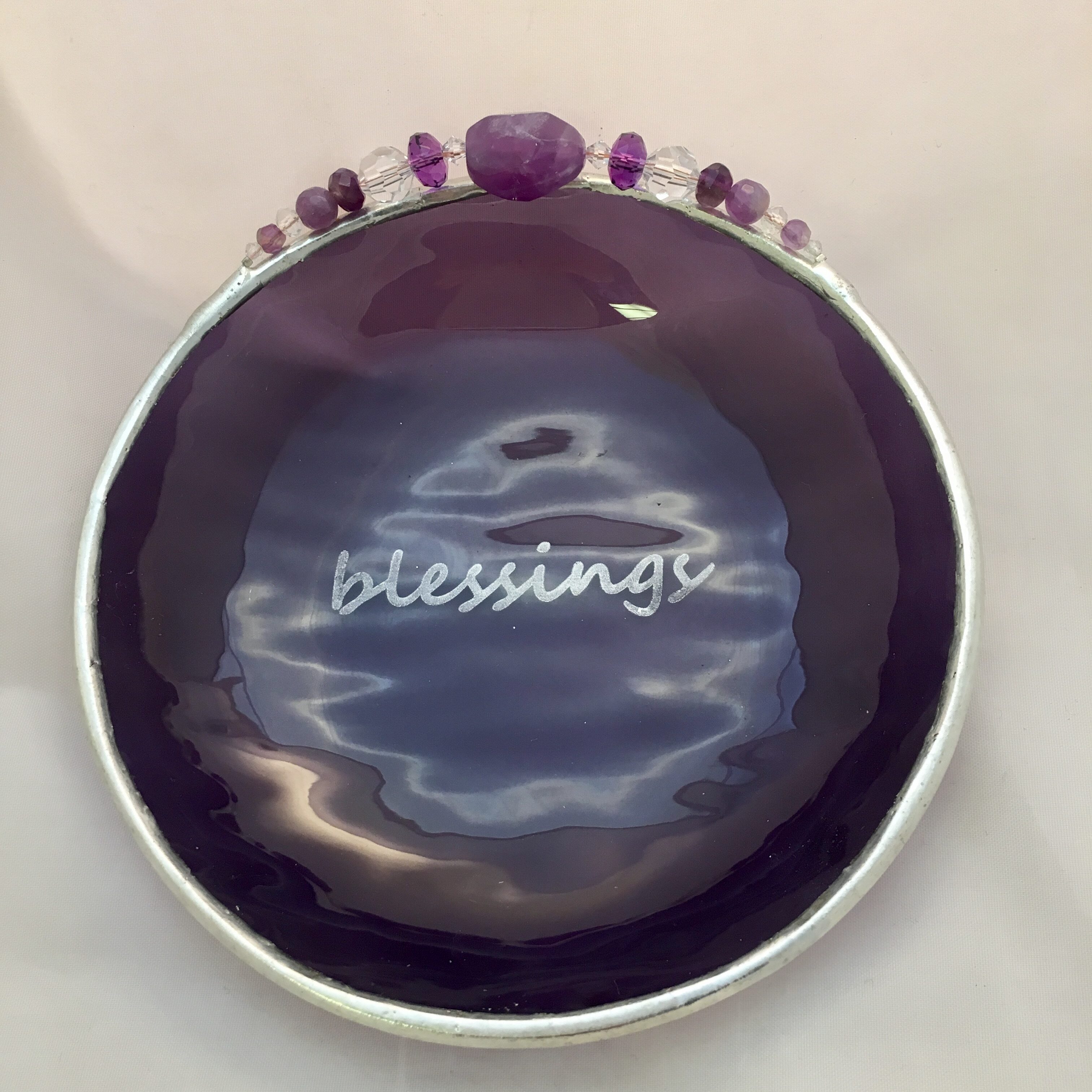 A purple dish with the word blessings written on it.