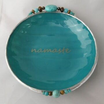 A blue plate with the word namaste written on it.