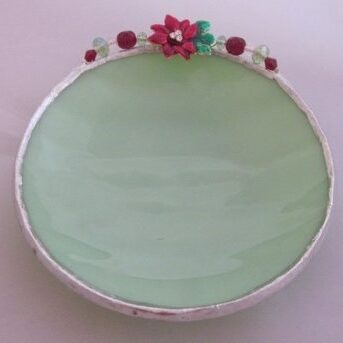 A green plate with flowers on top of it.