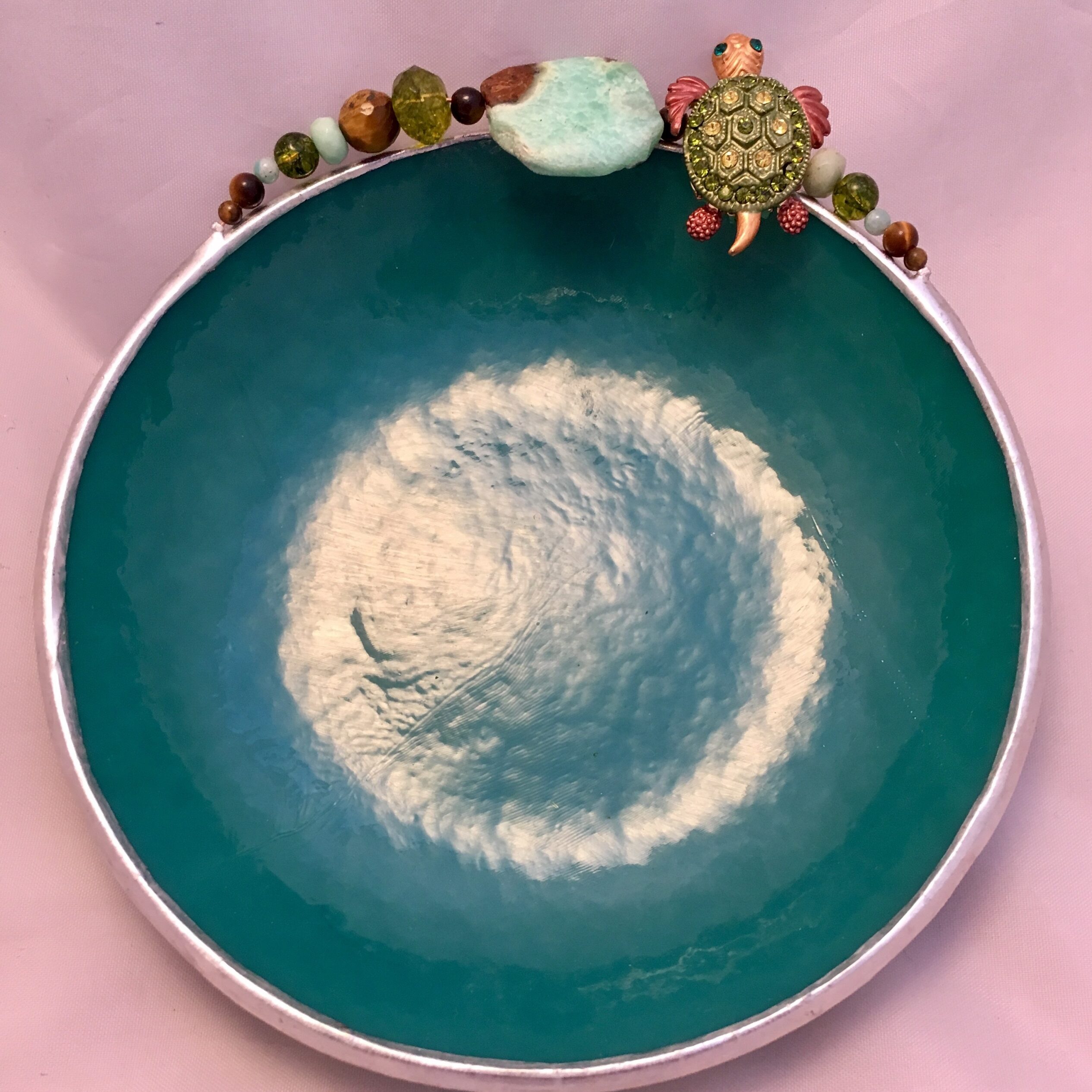 A bowl with a green and white design on it