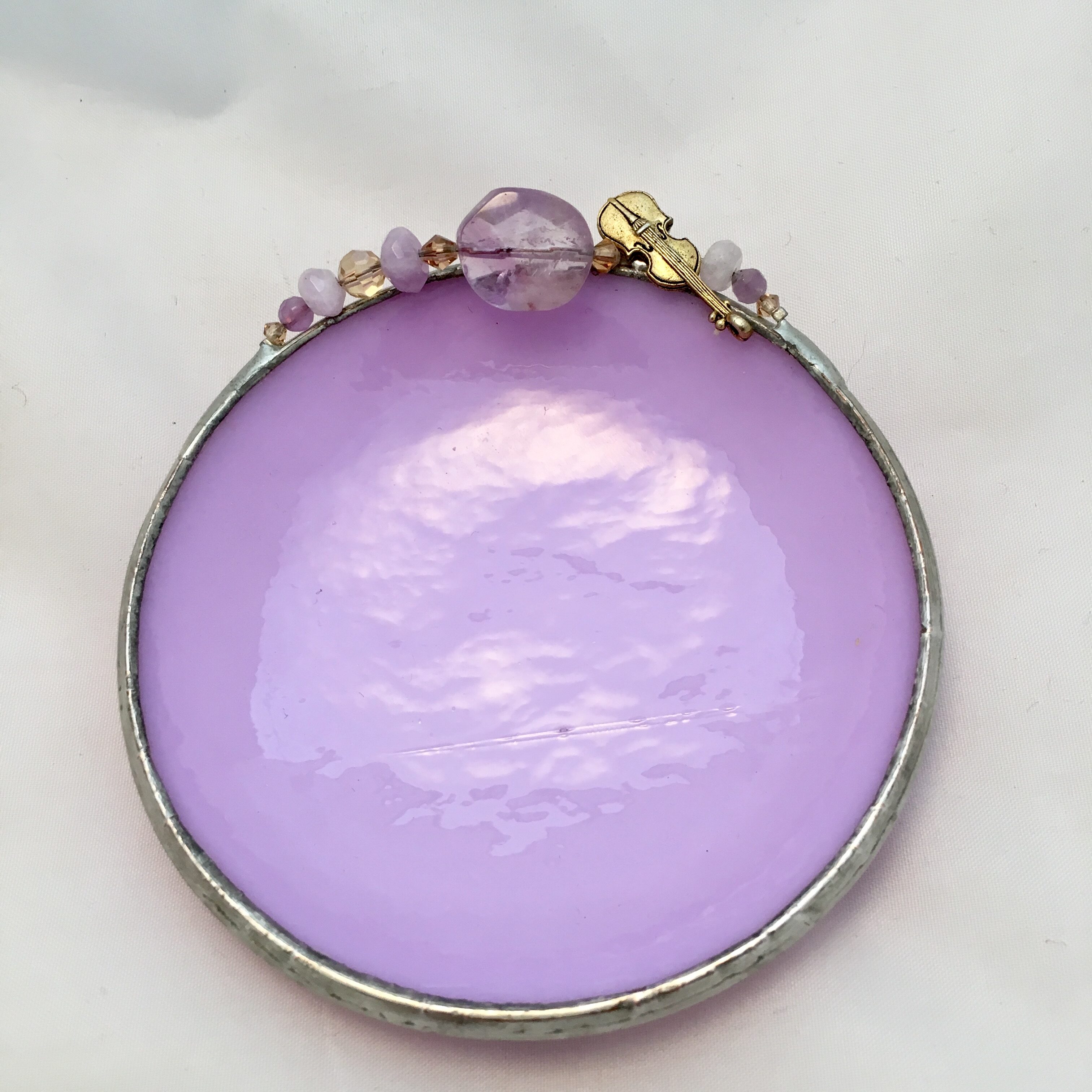 A purple glass dish with gold accents.