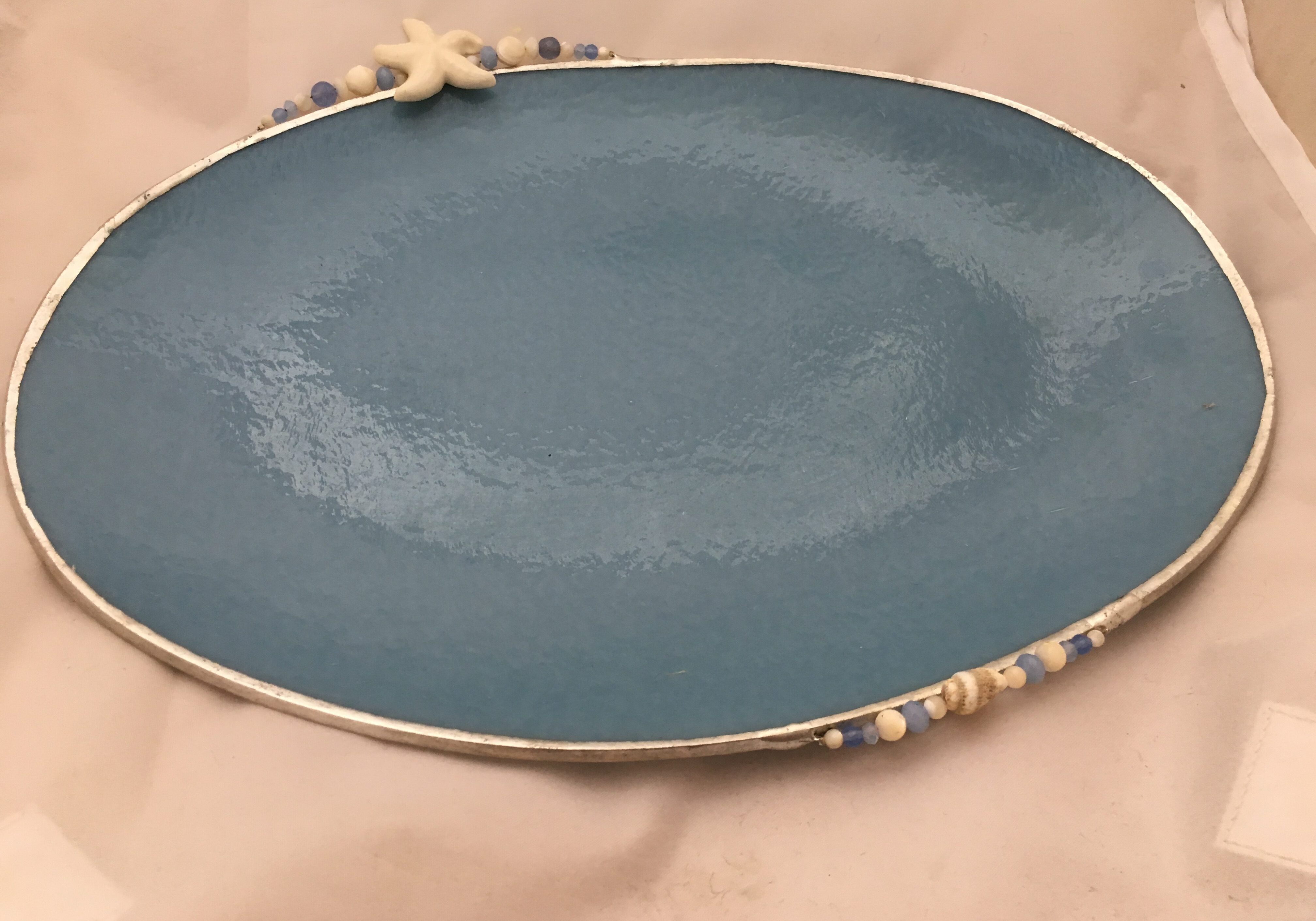 A blue plate with shells on it