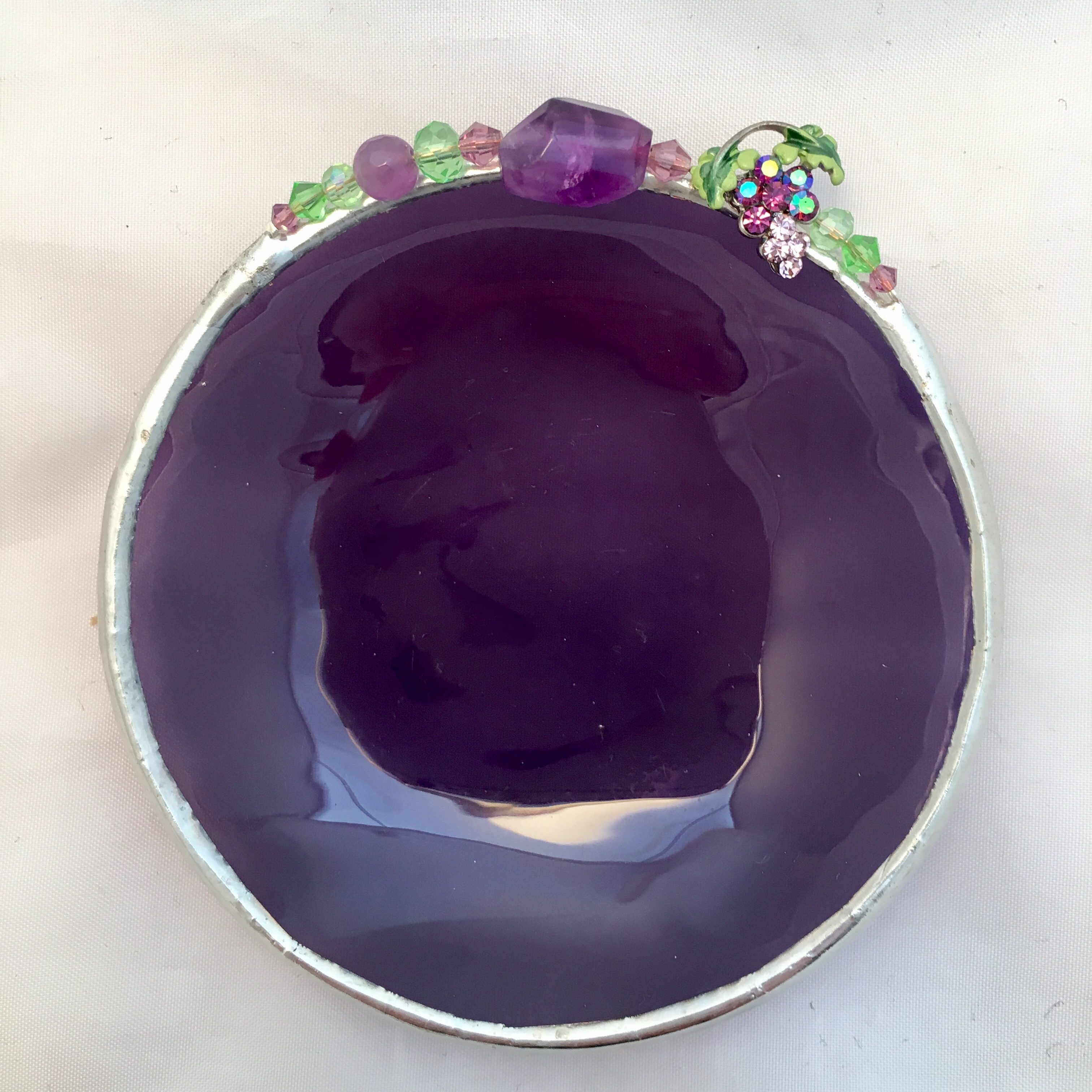 A purple bowl with flowers on top of it.