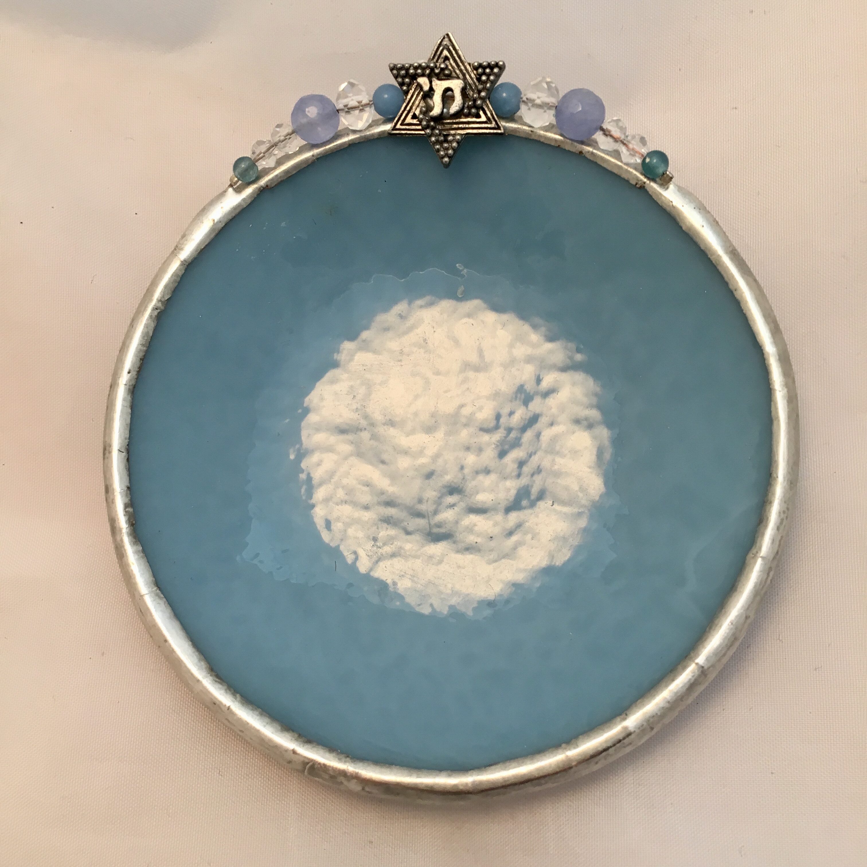 A blue plate with a white cloud in it