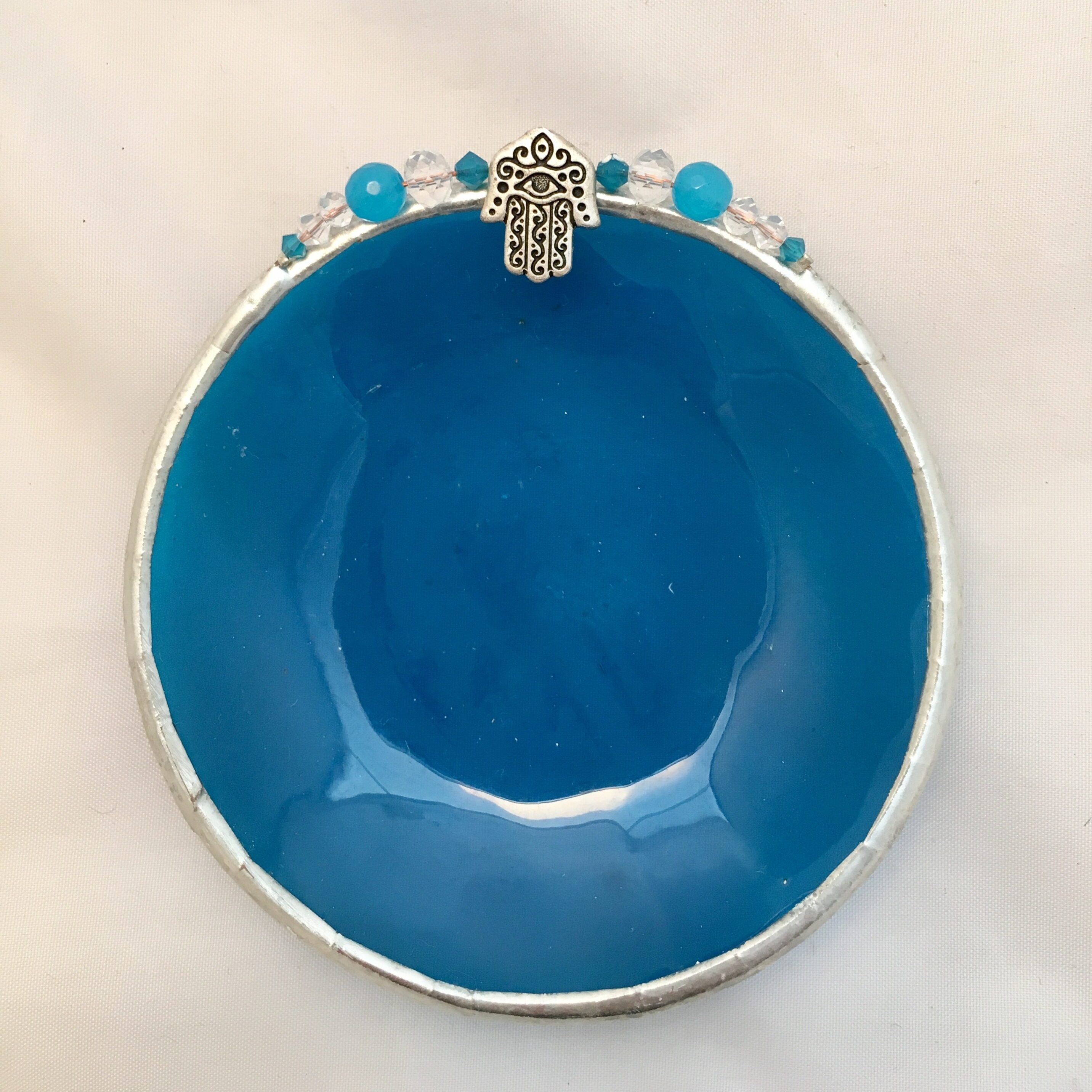 A blue bowl with a cross on it