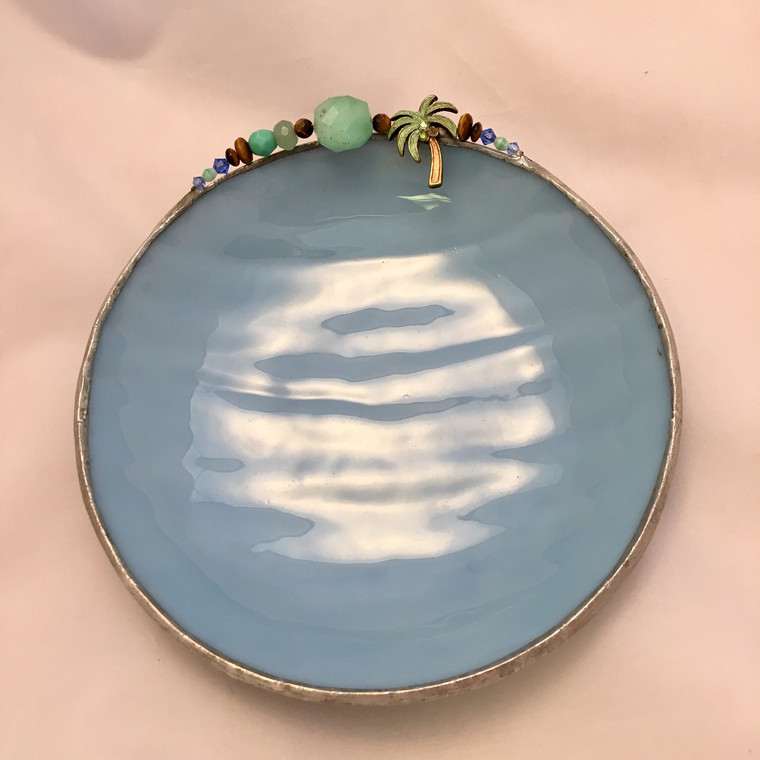 A blue plate with a palm tree on it