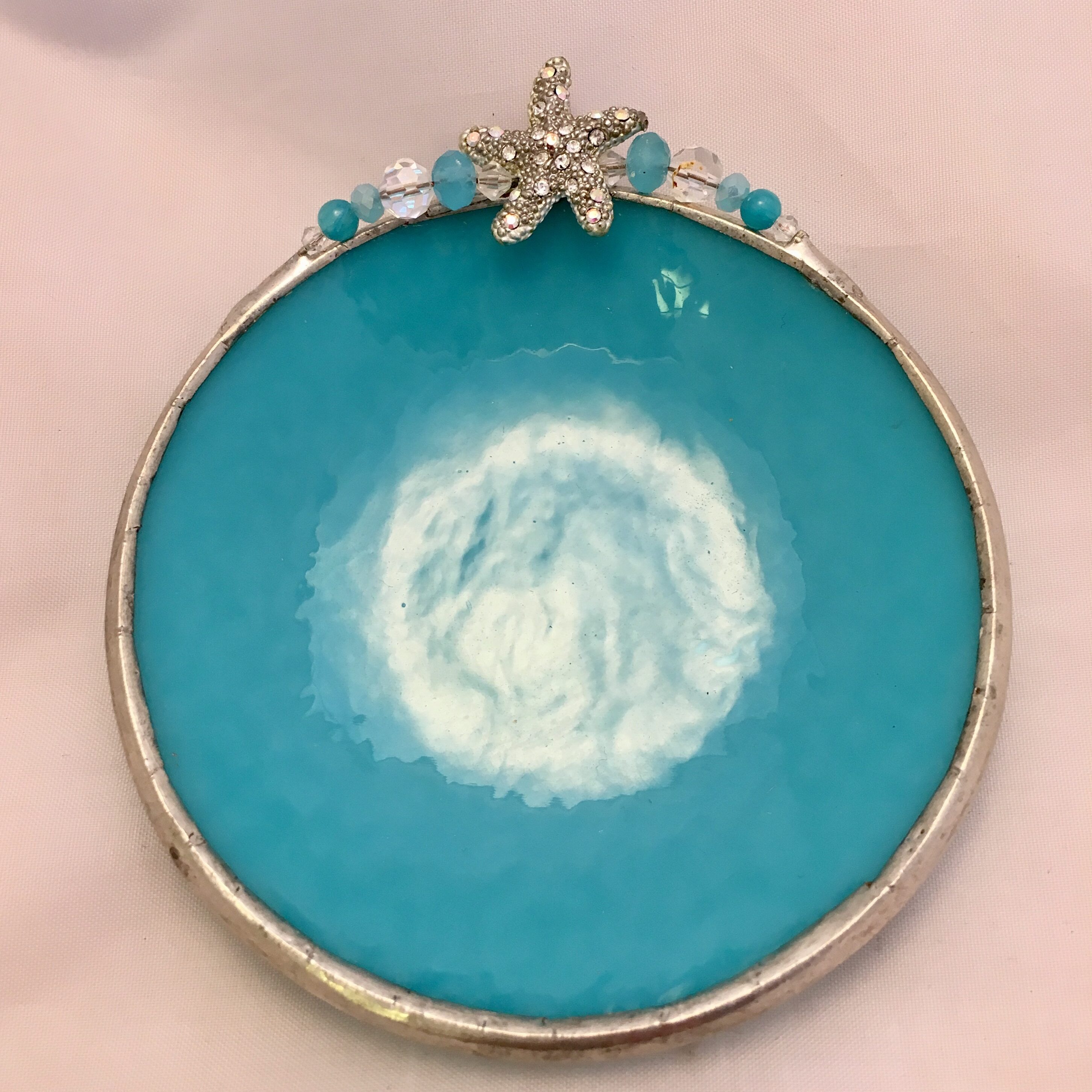 A blue plate with a silver rim and a star on top.